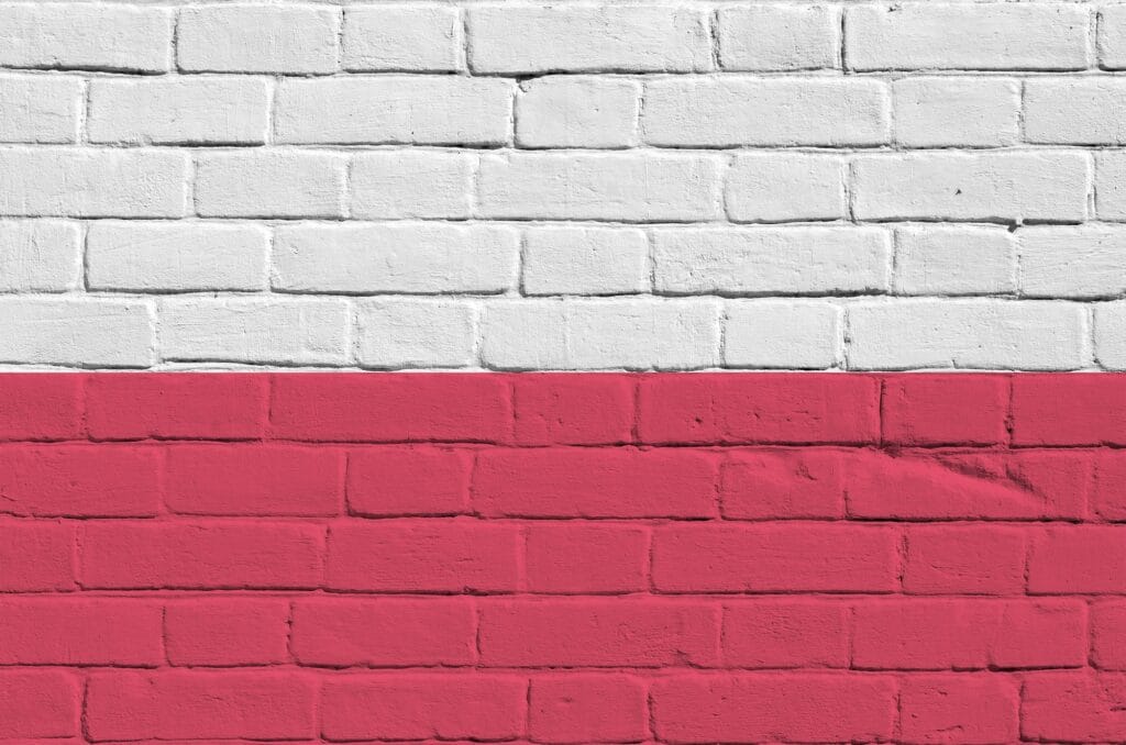 Poland flag depicted in paint colors on old brick wall close up